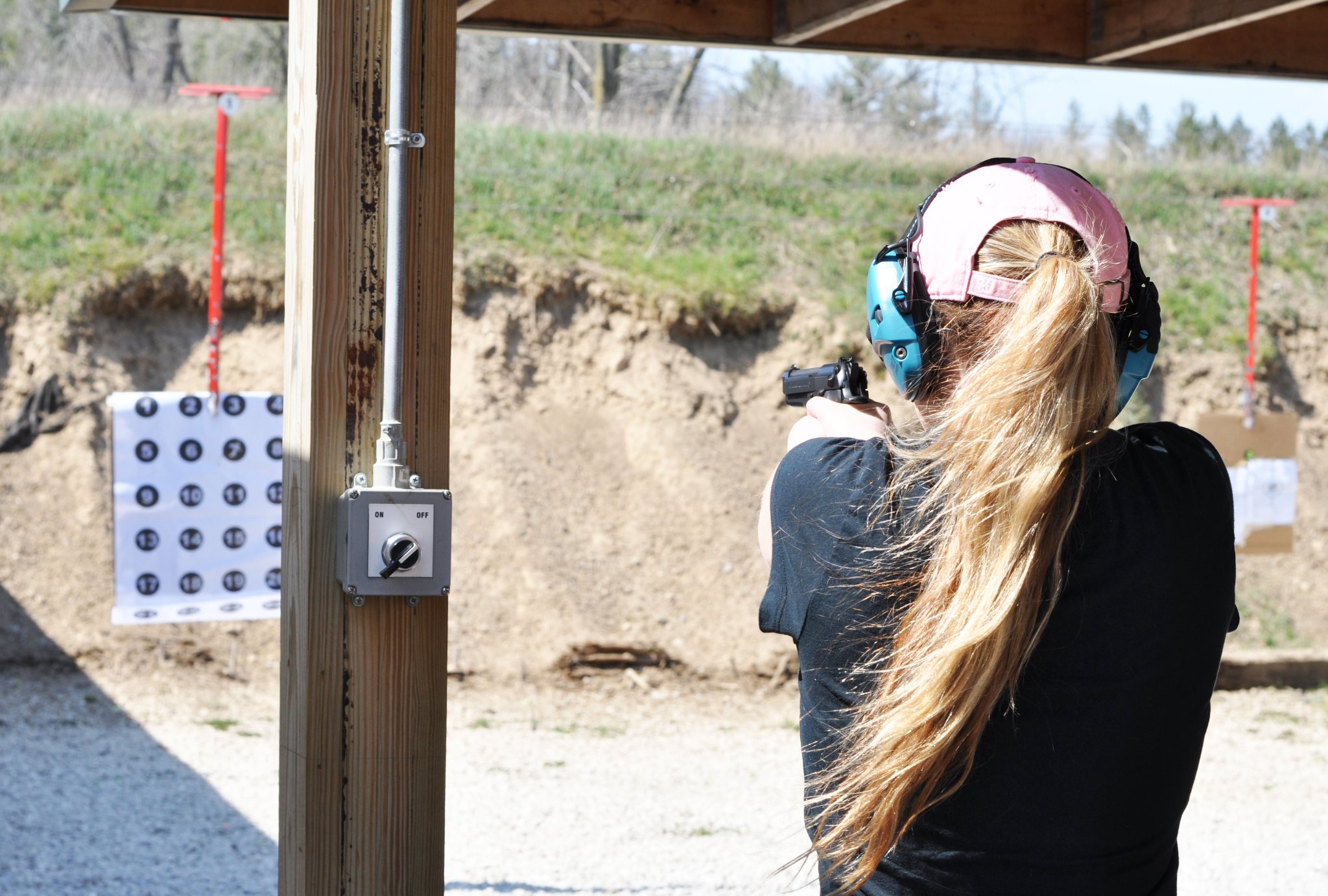 Female student pistol drill — outdoor range